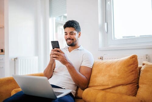 Man on his phone and laptop