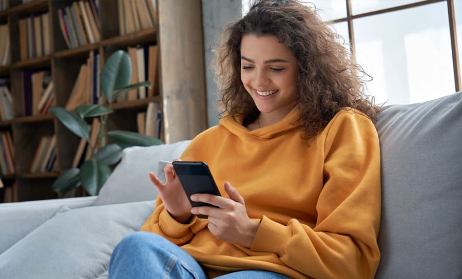 Woman smiling at phone